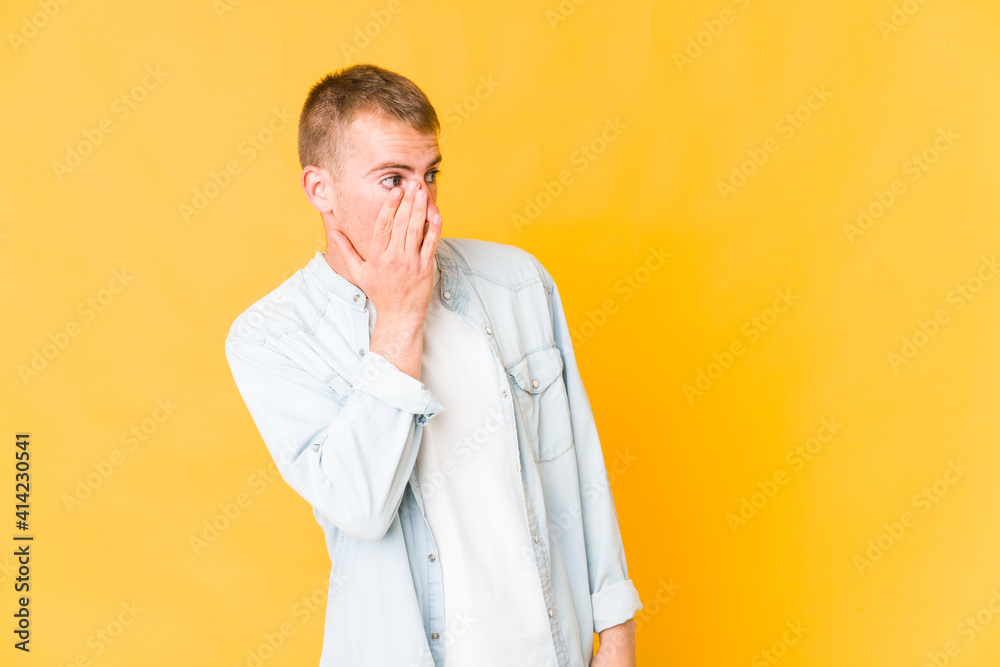 Young caucasian handsome man being shocked because of something she has seen.