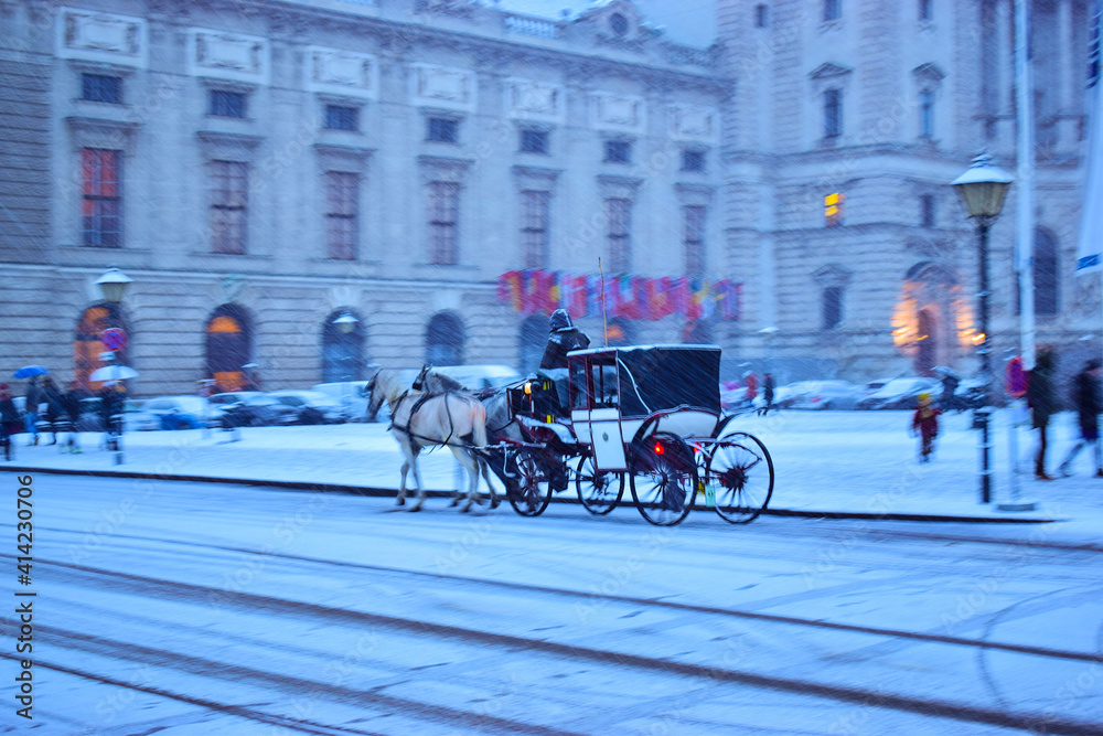 Horse-Drawn Carriage in Vienna Austria on a winter evening in the city with beautify snowfall 