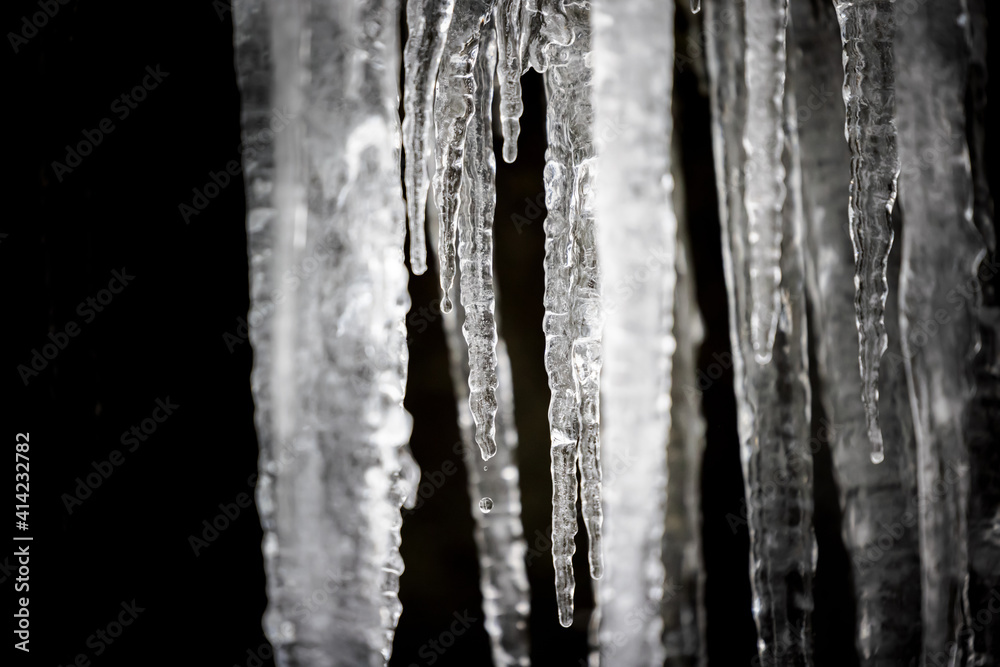 Closeup of frozen icicles on black background