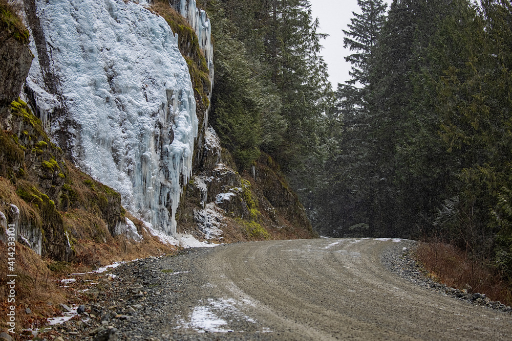 Large icicles on side of mountain along forestry road in February