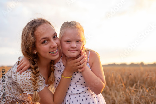 Portrait of beautiful young girls outside, down syndrom