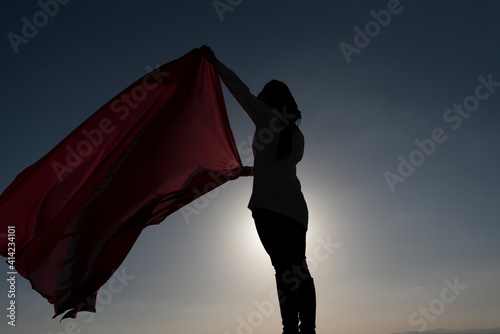 Silhouette of a woman with red shawl 