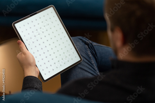 Картината върху платно Young man reading e-book, news. Digital tablet.