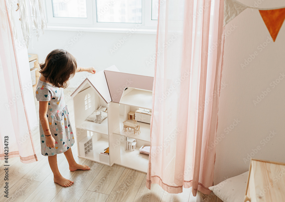 Girl playing with doll house Girl playing with doll house
