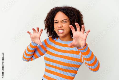 Young african american mixed race woman isolated showing claws imitating a cat, aggressive gesture.