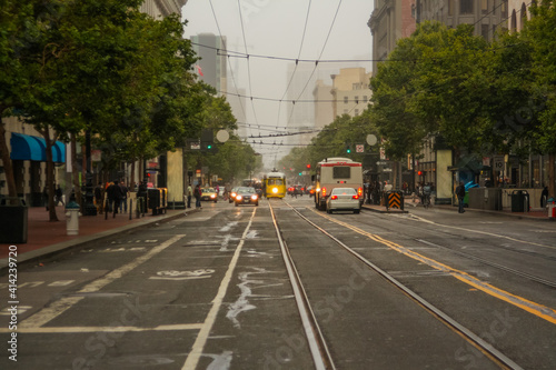 A night shot of a straight road, cable car and cars in San Francisco, California, United States of America aka USA