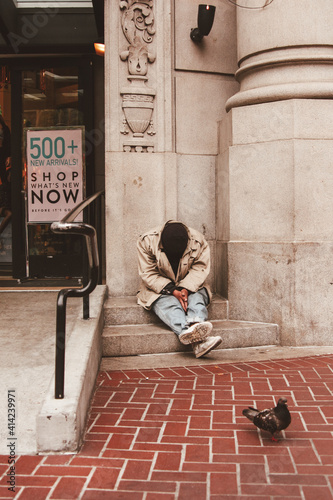 Homeless man sitting outside a luxury shopping mall, San Francisco, California, united States of America aka USA