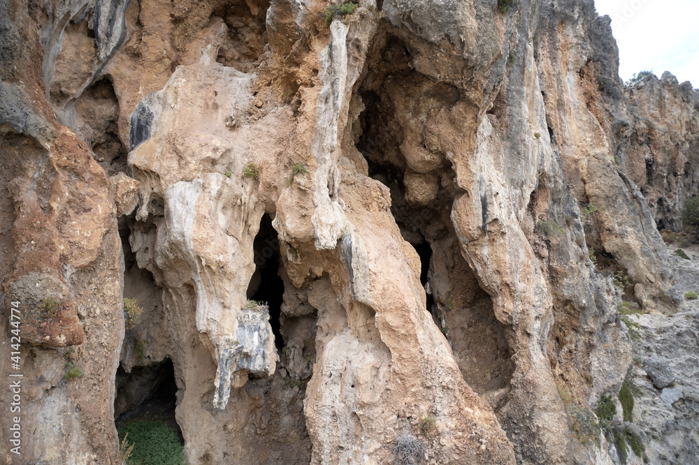 Texture of big rock formation. Large rocky cliff close up. Old weathered eroded rock.