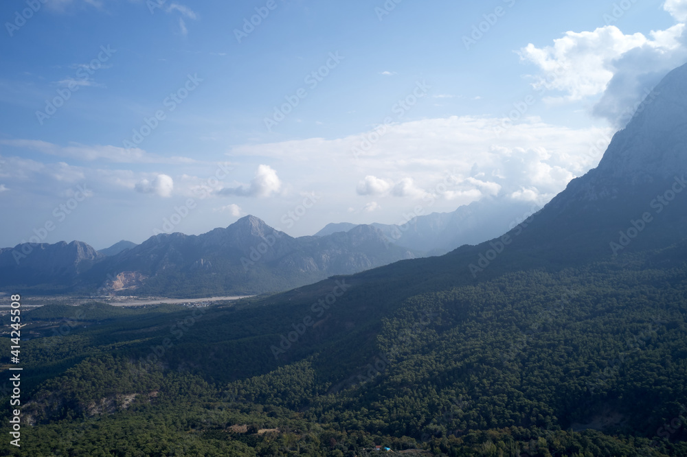 Beautiful mountain landscape with forests. View to forested mountain valley in the morning. Beautiful mountain landscape with forests. View to forested mountain valley in the morning.