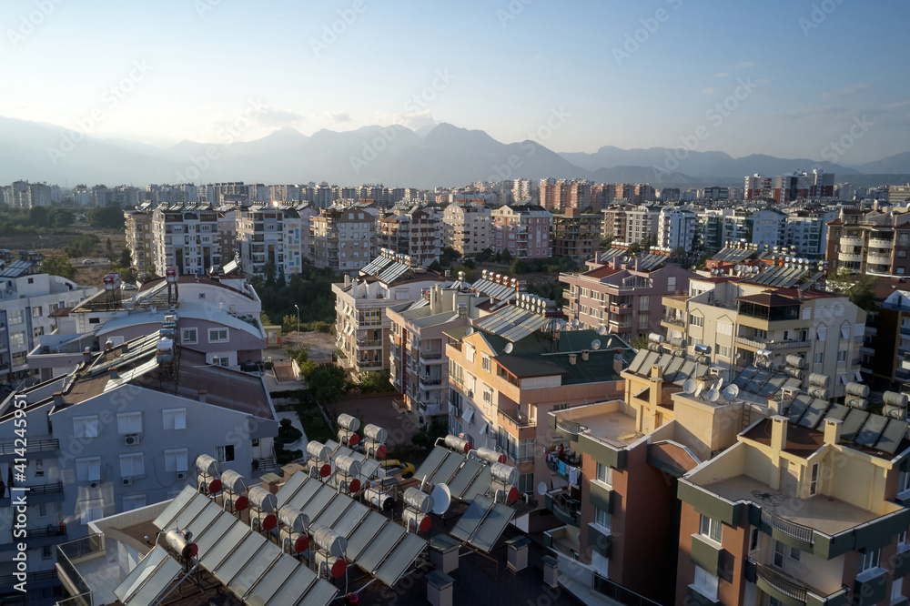Urban landscape with views of multi-storey colored houses. Sky and mountains in the background. Antalya, Turkey.