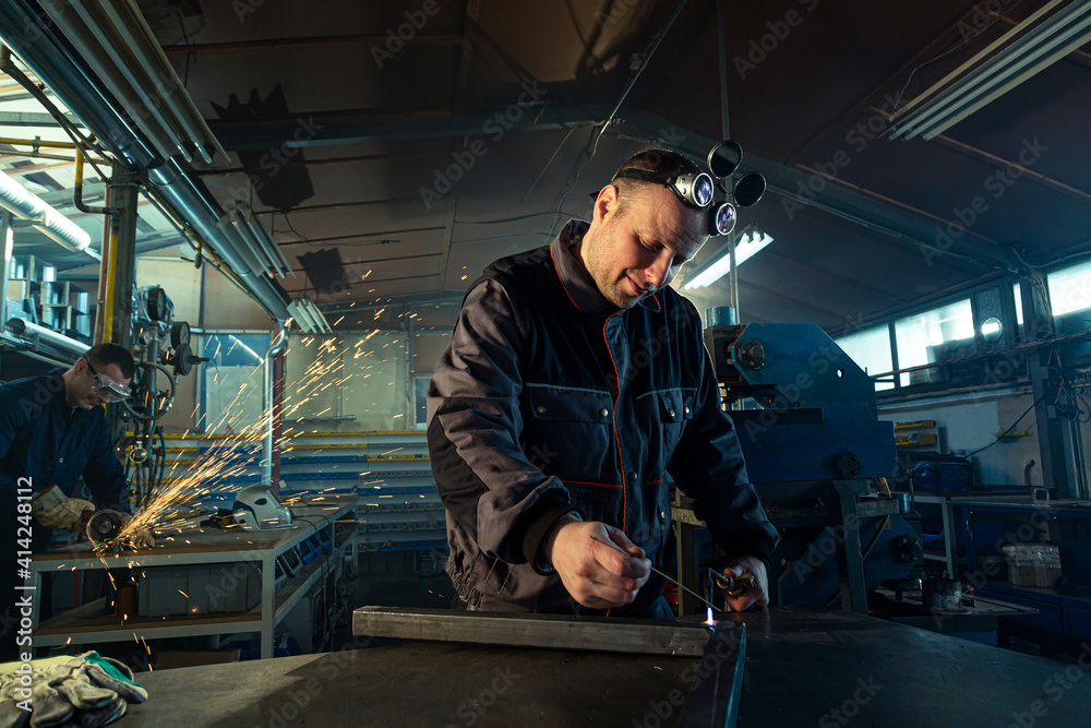 Welder working with autogenous welding tool in workshop Welder working with autogenous welding tool in workshop