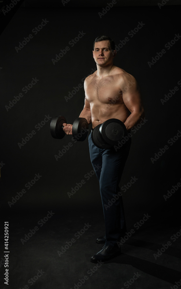 Man in trousers with dumbbells handsome, young guy Salesman trendy, trendy cool background black bodybuilder business elegance fashion portrait attractive confidence happy, studio elegant. Salesman Man in trousers with dumbbells handsome, young guy Salesman trendy, trendy cool background black bodybuilder business elegance fashion portrait attractive confidence happy, studio elegant. Salesman