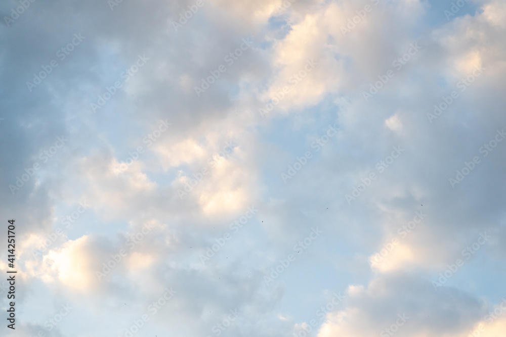 Blue sky with soft clouds background.
