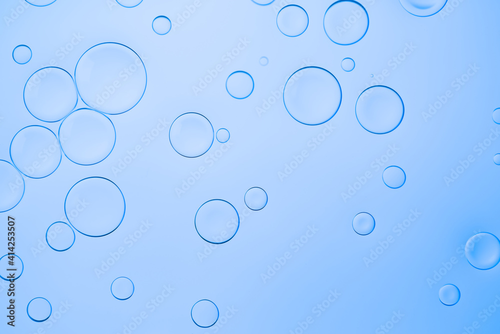 Creative neon background with drops. Glowing abstract backdrop with vibrant gradients on bubbles. Blue overflowing color