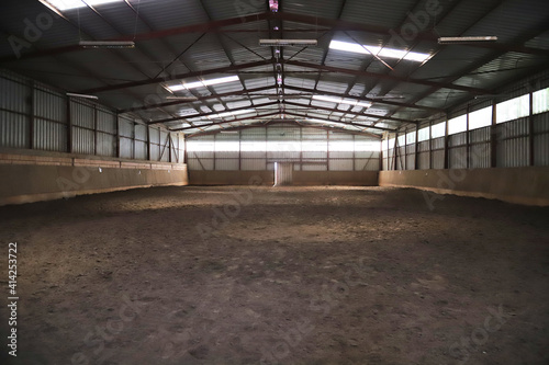 Photo of an empty indoor riding hall for horses and riders © acceptfoto