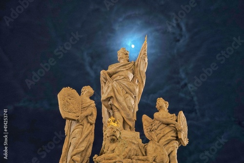 Statue of St. Wenceslaus with St. Vitus and St. Ludmila of Bohemia in Kutna Hora, Czech Republic, by night. Relief depicting the murder of St. Wenceslaus. Main patron saint of Bohemia. photo