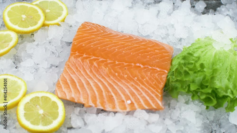 fresh salmon fillet on ice with salad and lemon slice fresh salmon fillet on ice with salad and lemon slice