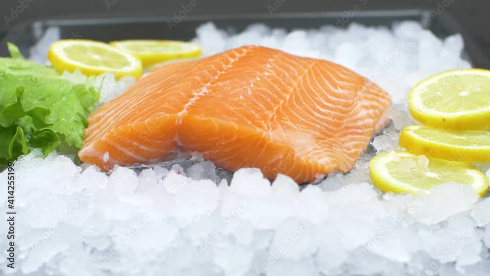fresh salmon fillet on ice with salad and lemon slice fresh salmon fillet on ice with salad and lemon slice