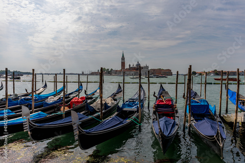 Gondolas parked on a pier in Venice Italy. © Armensl