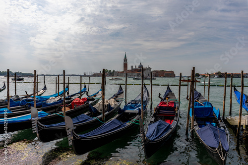 Gondolas parked on a pier in Venice Italy.