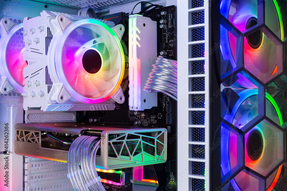 Inside view of custom colorful illuminated bright rainbow RGB LED gaming pc. Computer power hardware and technology concept background - obrazy, fototapety, plakaty 