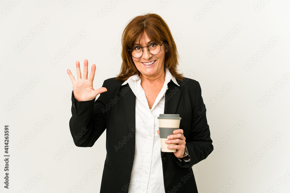 Middle aged business woman holding a takeaway coffee isolated smiling cheerful showing number five with fingers. Middle aged business woman holding a takeaway coffee isolated smiling cheerful showing number five with fingers.
