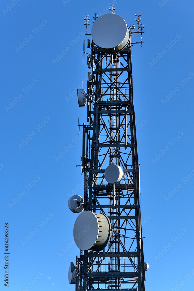 Beautiful close up view of Three Rock TV transmitter antenna viewed from Fairy Castle (Two Rock Mountain), Dublin Mountains, Ireland. Single cellular tower top in against clear blue sky. Vertical view