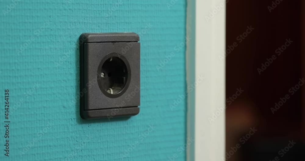 Electric outlet plugging and unplugging a white power cord, European Type F Electric outlet plugging and unplugging a white power cord, European Type F