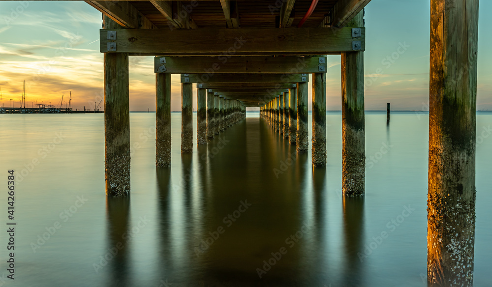 Under a pier View at sunset at Fairhope, Alabama. Under a pier View at sunset at Fairhope, Alabama.