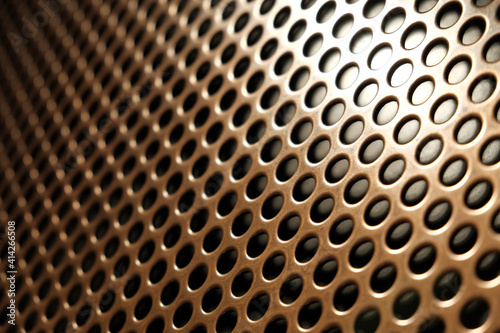 bronze shiny metal grille
 as an abstract background
