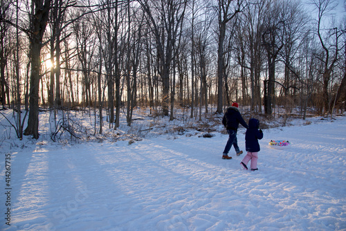 Father and daughter walking with the face mask in the park in winter. Covid-19, winter, outside, healthy lifestyle.