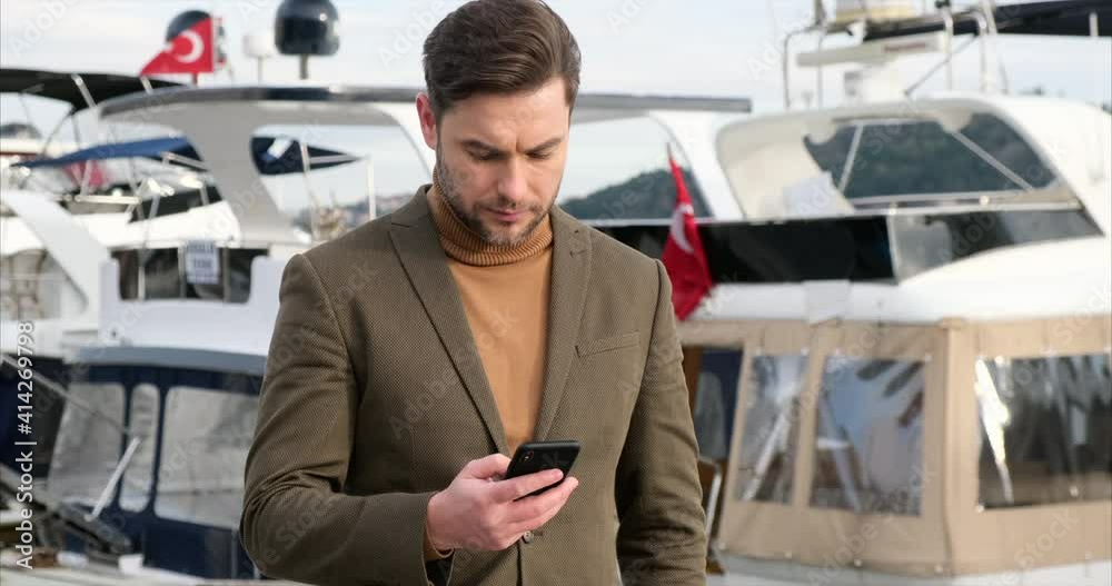 Happy smiling businessman wearing braun suit and using modern smartphone,Bebek Happy smiling businessman wearing braun suit and using modern smartphone,Bebek