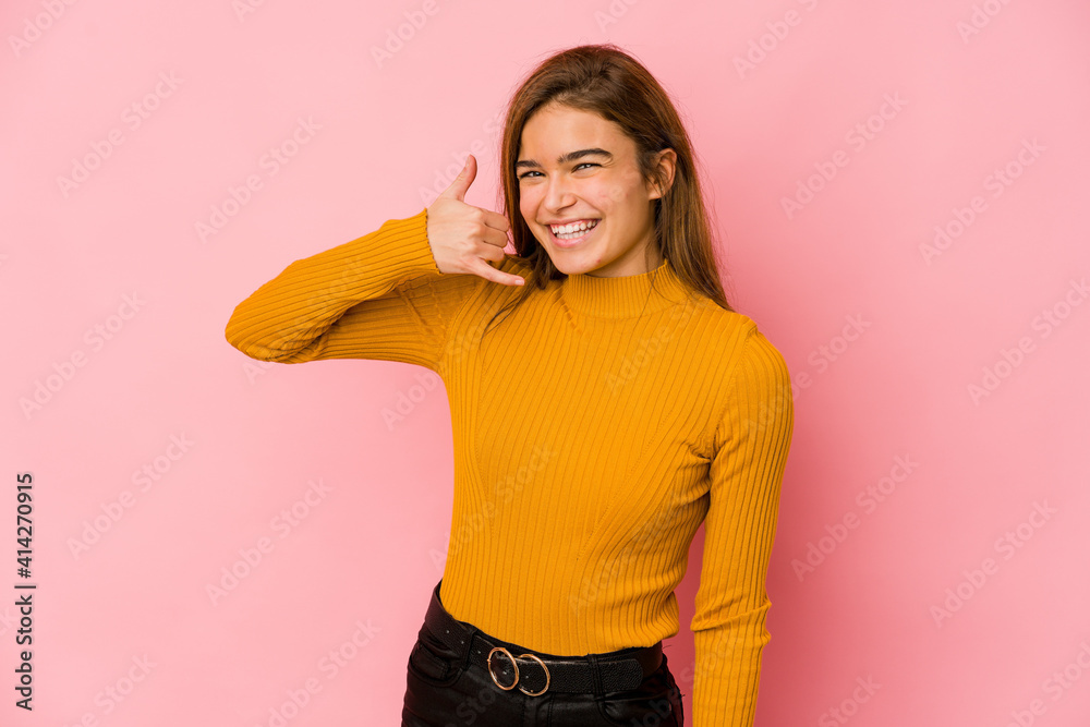 Young skinny caucasian teenager girl showing a mobile phone call gesture with fingers. Young skinny caucasian teenager girl showing a mobile phone call gesture with fingers.
