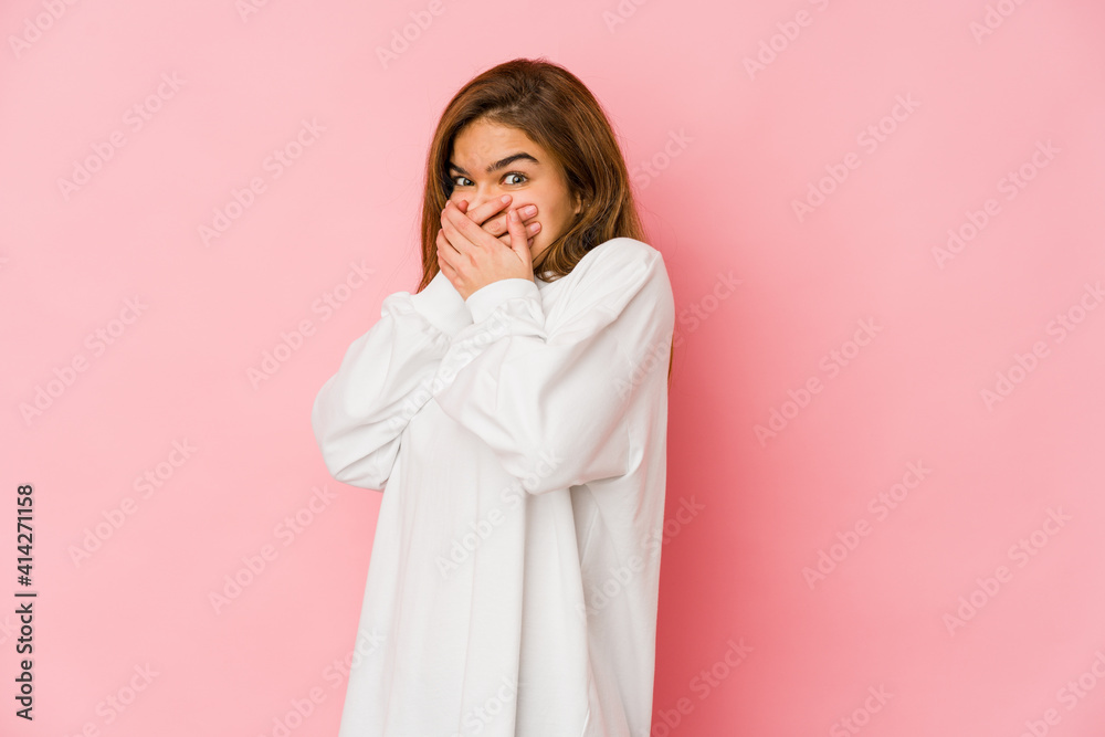Young skinny caucasian teenager girl thoughtful looking to a copy space covering mouth with hand.
