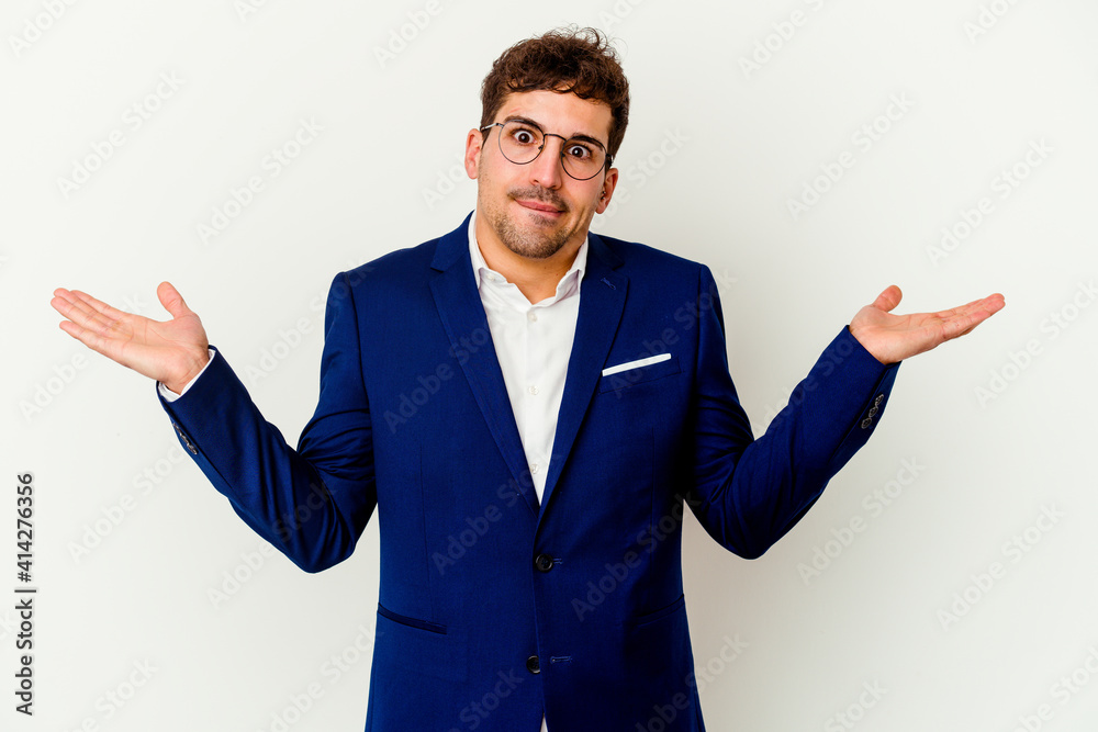 Young business caucasian man isolated on white background confused and doubtful shrugging shoulders to hold a copy space. Young business caucasian man isolated on white background confused and doubtful shrugging shoulders to hold a copy space.