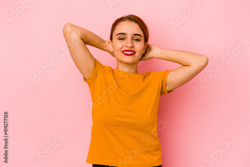 Young arab mixed race woman feeling confident, with hands behind the head.
