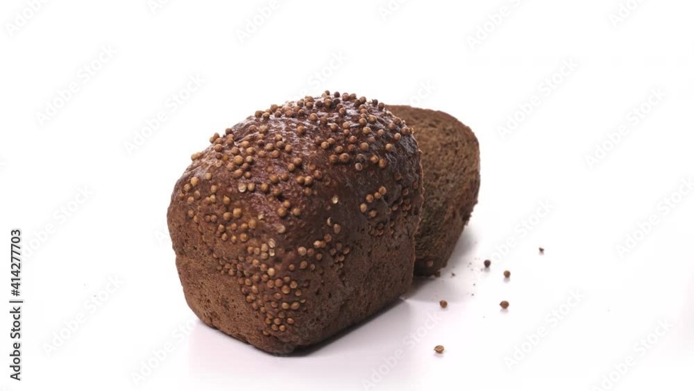 beautiful loaf of black sliced bread, ready for breakfast with sprinkles spinn on white background. Fresh bread, just from the oven on turntable isolated. beautiful loaf of black sliced bread, ready for breakfast with sprinkles spinn on white background. Fresh bread, just from the oven on turntable isolated.