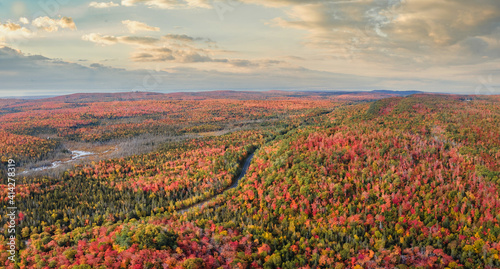 Sunset Autumn drive through the tunnel of Trees in Michigan Upper Peninsula UP - Highway 41  M26 Aerial view
