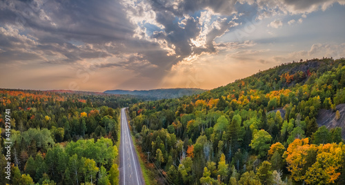 Sunset Autumn drive through the tunnel of Trees in Michigan Upper Peninsula UP - Highway 41 M26 Aerial view