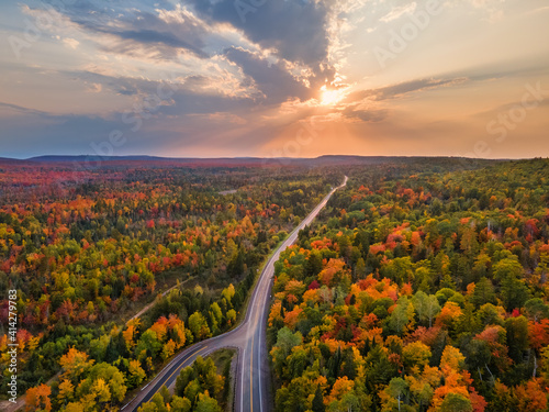 Sunset Autumn drive through the tunnel of Trees in Michigan Upper Peninsula UP - Highway 41  M26 Aerial view