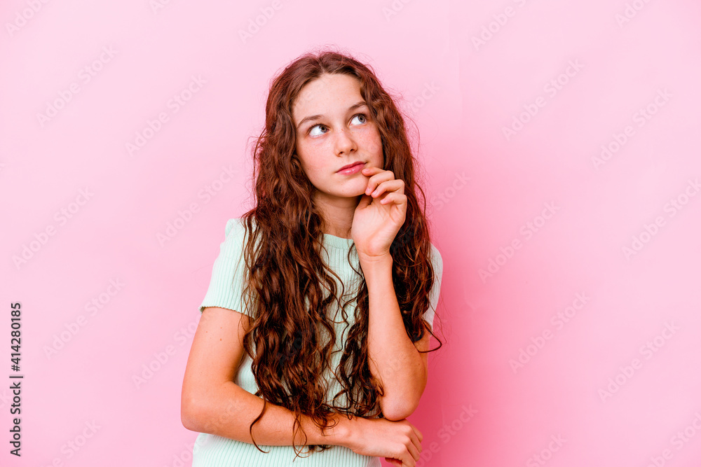 Little caucasian girl isolated on pink background contemplating, planning a strategy, thinking about the way of a business. Little caucasian girl isolated on pink background contemplating, planning a strategy, thinking about the way of a business.