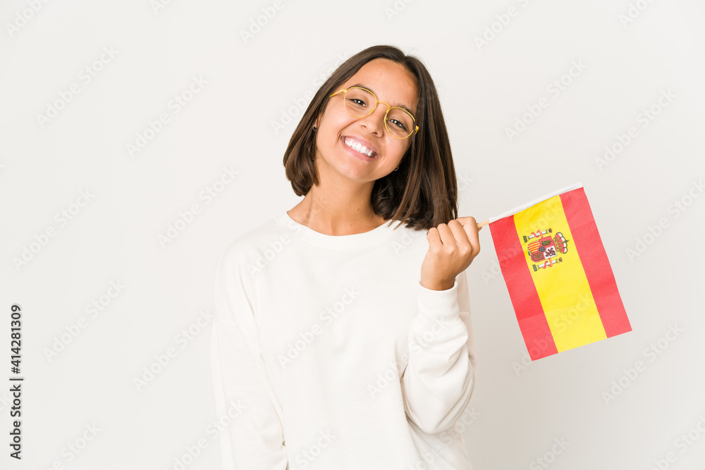 Young hispanic mixed race woman holding a spanish flag happy, smiling and cheerful. Young hispanic mixed race woman holding a spanish flag happy, smiling and cheerful.