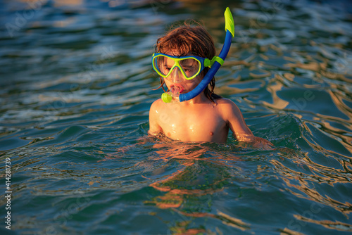 Snorkel swimming. Kid dives into the water. Extreme sport concept. Kids summer holidays. Diving equipment.