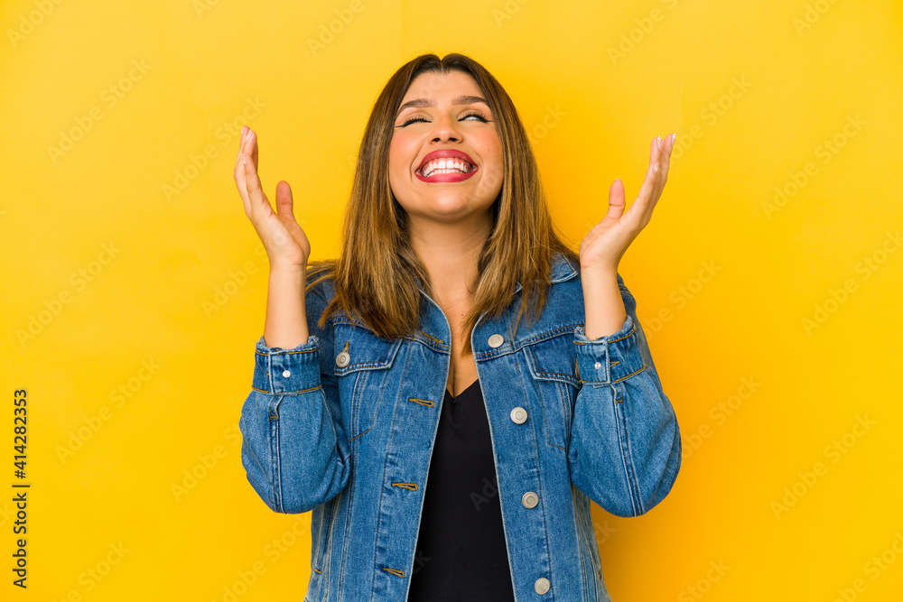 Young indian woman isolated on yellow background joyful laughing a lot. Happiness concept. Young indian woman isolated on yellow background joyful laughing a lot. Happiness concept.