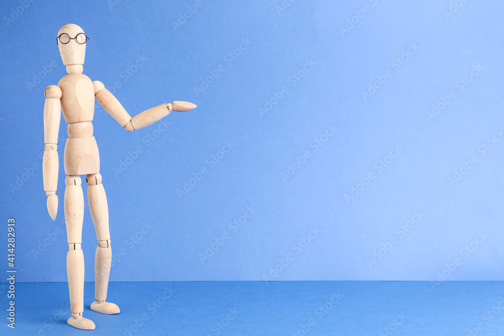 Wooden human figure in eyeglasses against light blue background, space for text Wooden human figure in eyeglasses against light blue background, space for text