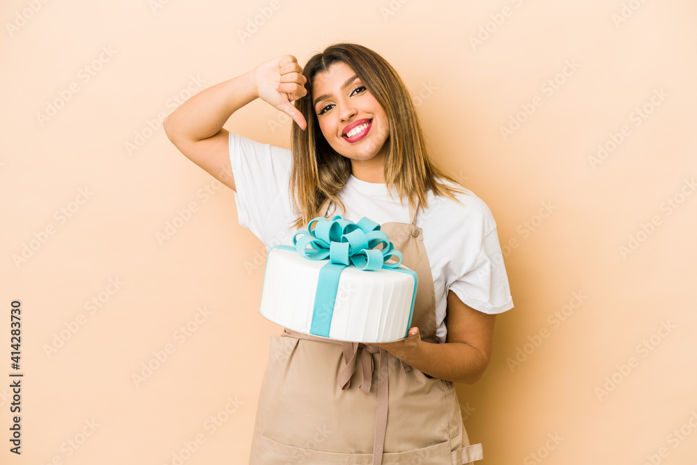 Young indian pastry chef woman isolated feels proud and self confident, example to follow. Young indian pastry chef woman isolated feels proud and self confident, example to follow.