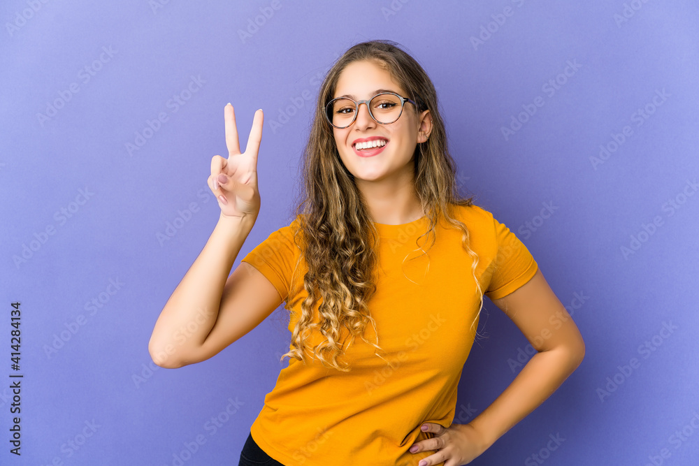 Fototapeta premium Young caucasian cute woman showing number two with fingers.
