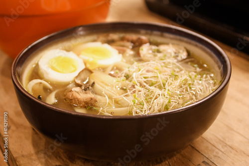 Ramen with boiled eggs, sprouts, and mushrooms