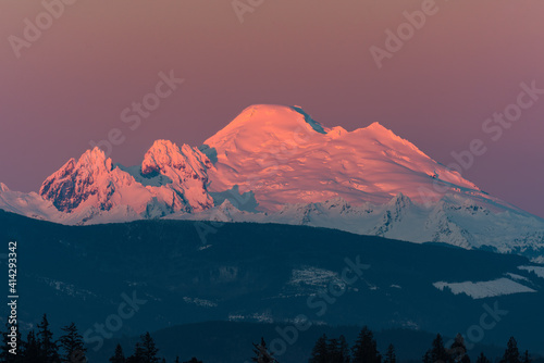 Photography Snow capped Mount Baker at sunset in pink alpenglow atop the prominent member of