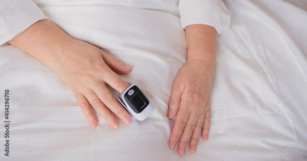 Retiree with blank clear pulse oximeter. Finger digital device to measure oxygen saturation in blood and heart rate. Pulseoximeter check vital sign during corona virus infection of the lungs. Covid 19